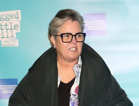 Rosie O'Donnell in a black jacket talking at an interview.